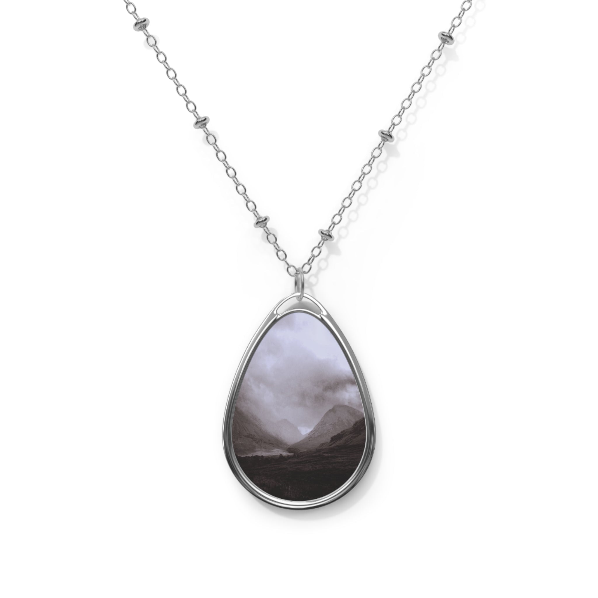 Silver chain necklace with teardrop pendant featuring a Scottish landscape painting
