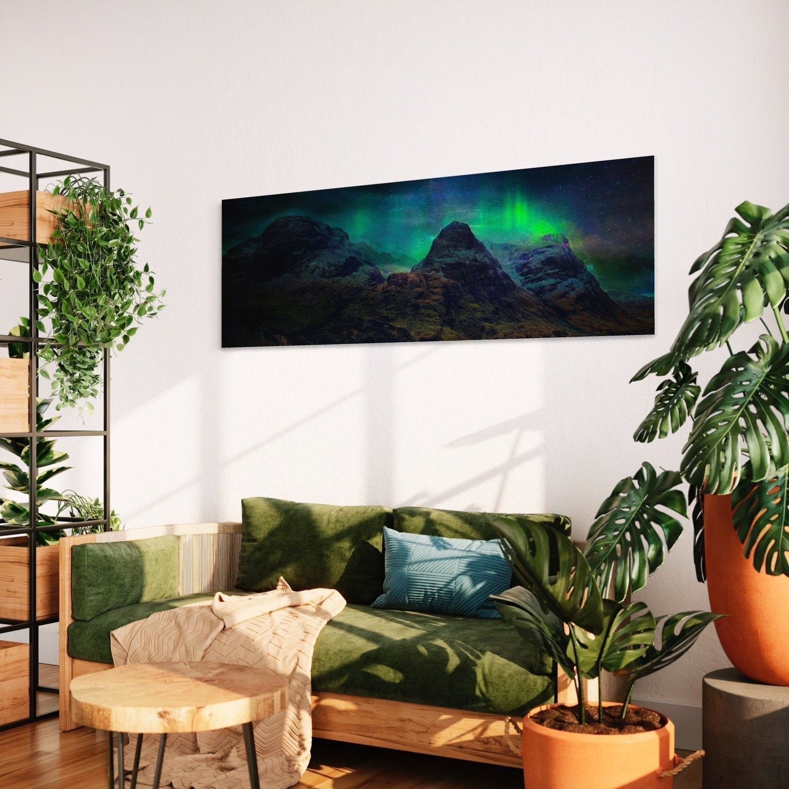 Living room with green sofa featuring Glencoe Northern Lights Scottish wall art