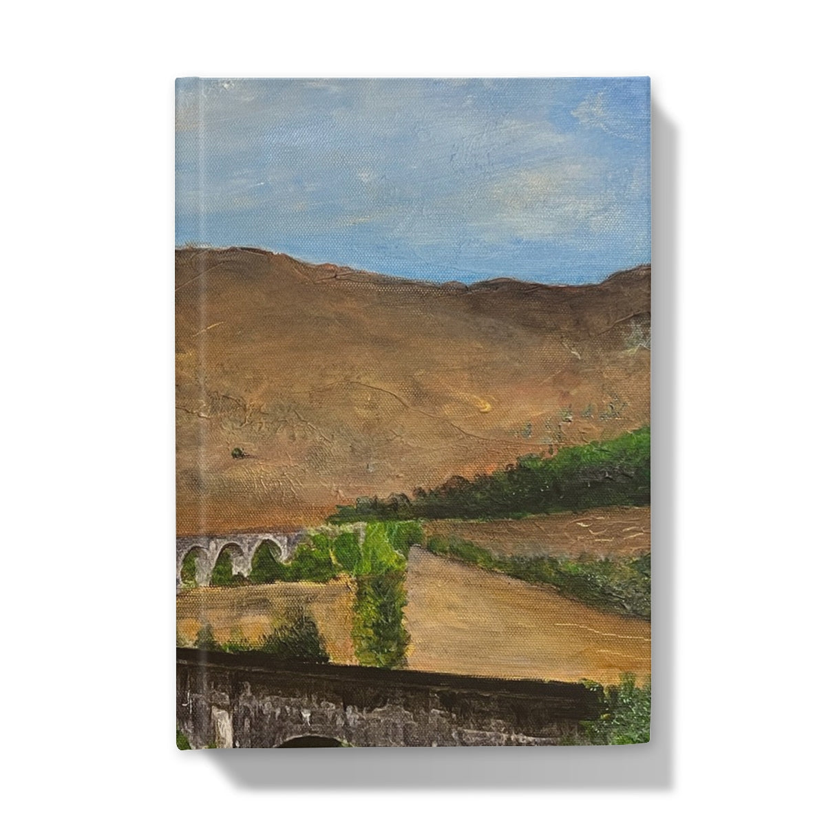 Brown stone arched bridge with green trees on Glenfinnan Viaduct journal