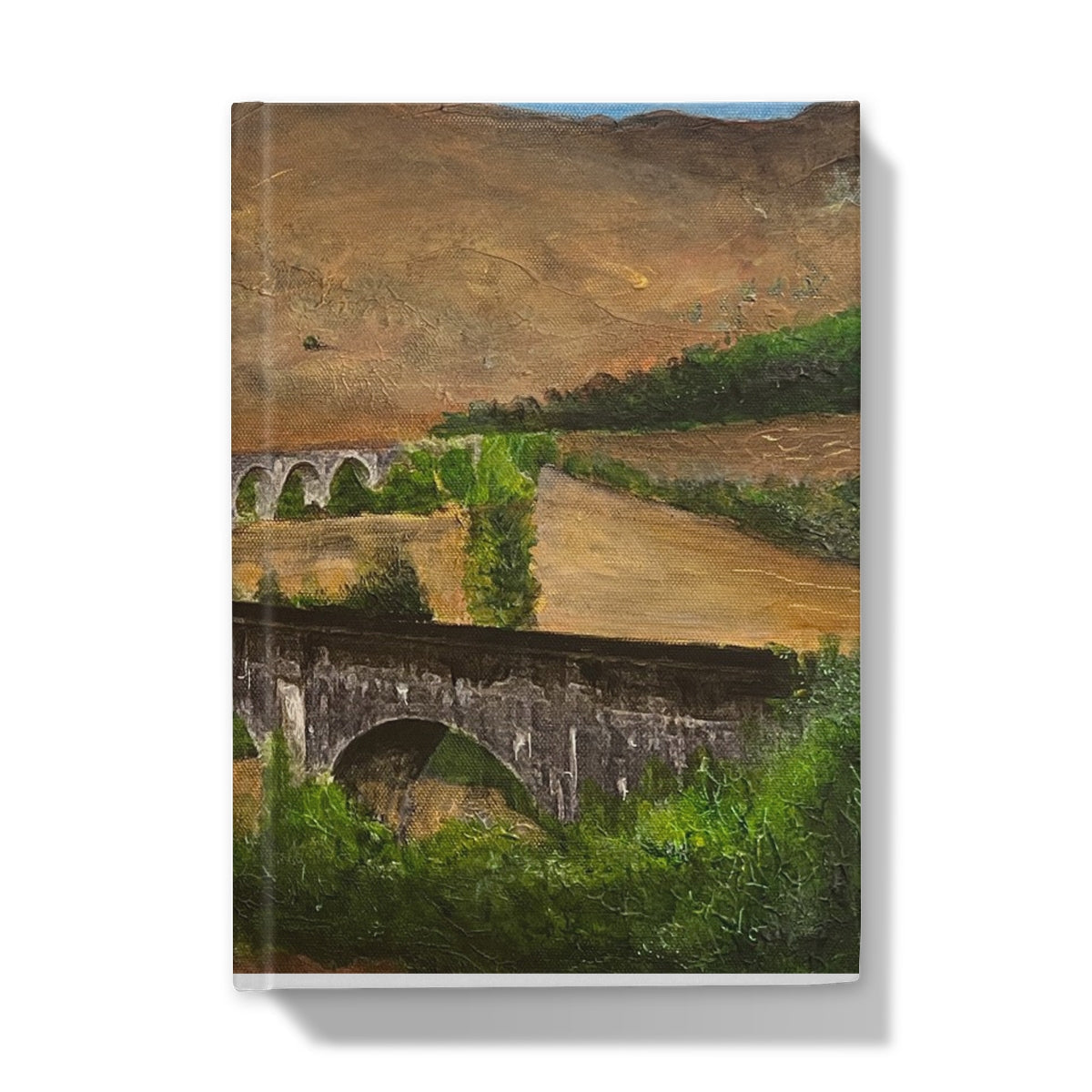 Hardcover journal featuring landscape painting of two stone bridges in a valley