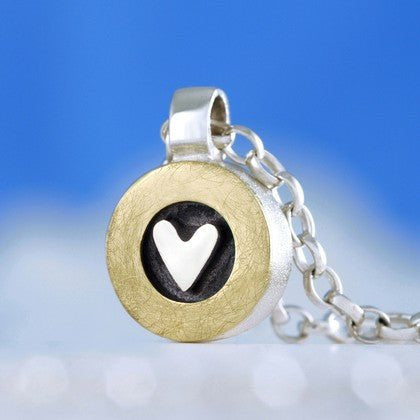 From the heart pendant with gold ring, black center, white heart on silver chain by Alan Ardiff Jewellery