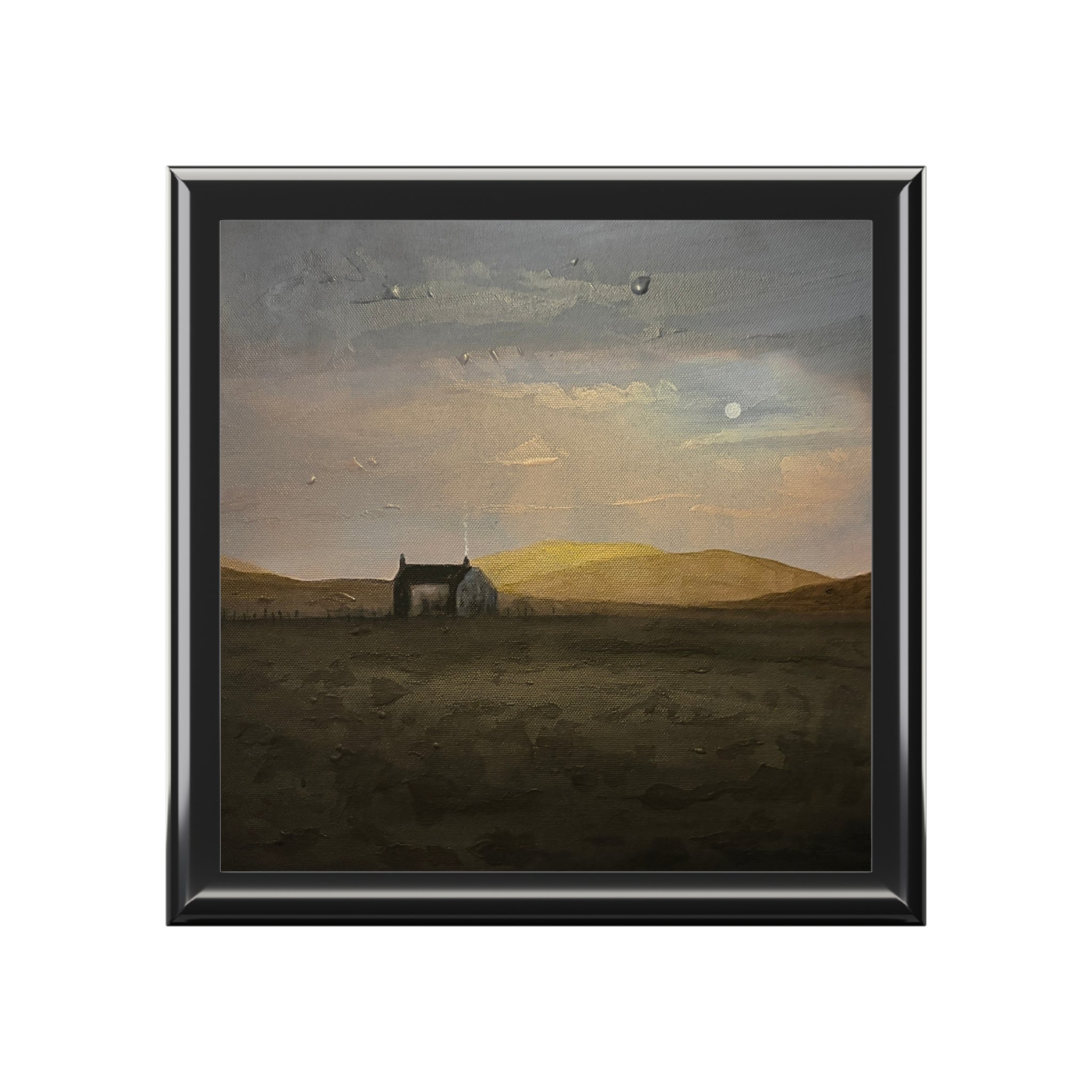 Black-framed square painting of Hebridean Croft House under moody sky with golden hills