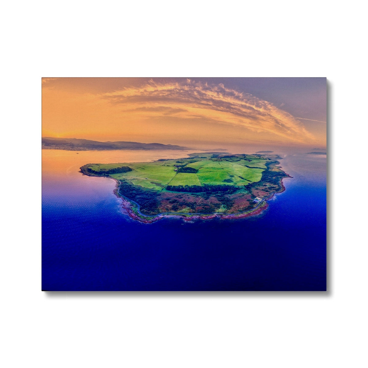 Vibrant Isle of Cumbrae canvas print with green fields, blue ocean, orange sunset