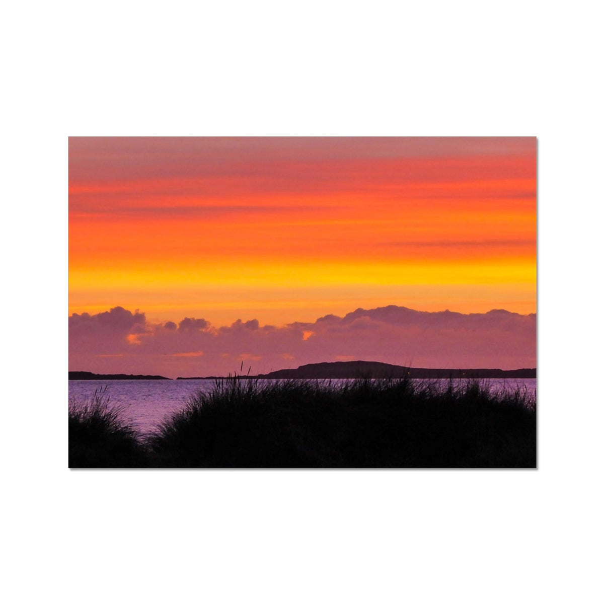 Vibrant Isle of Gigha post-sunset canvas print with orange, yellow, pink hues over silhouetted clouds and distant land