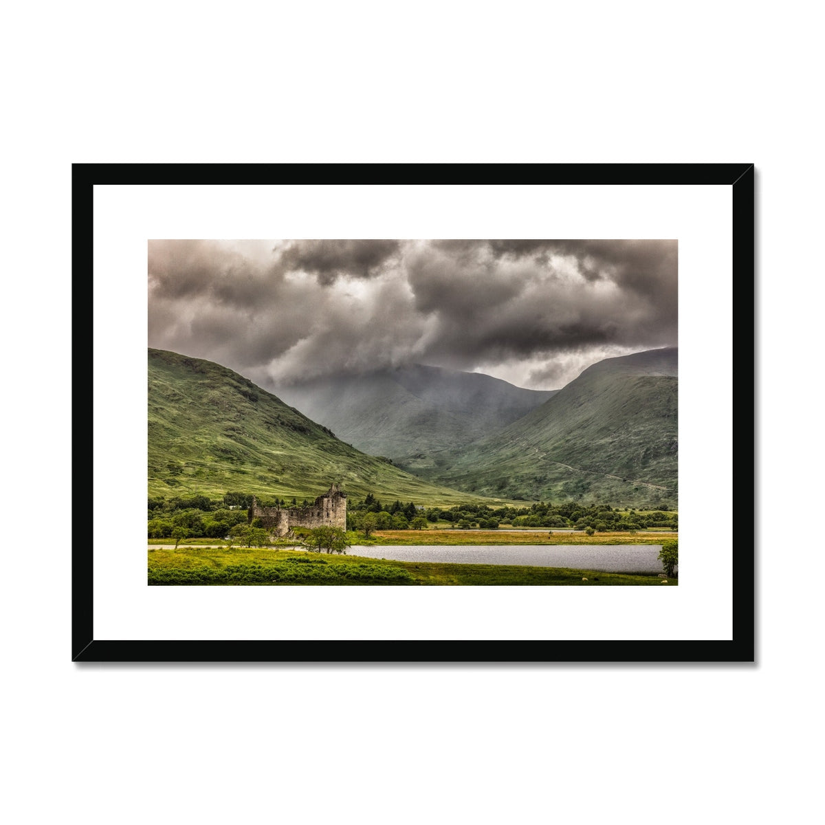 Black-framed Kilchurn Castle print with dramatic sky and mountains
