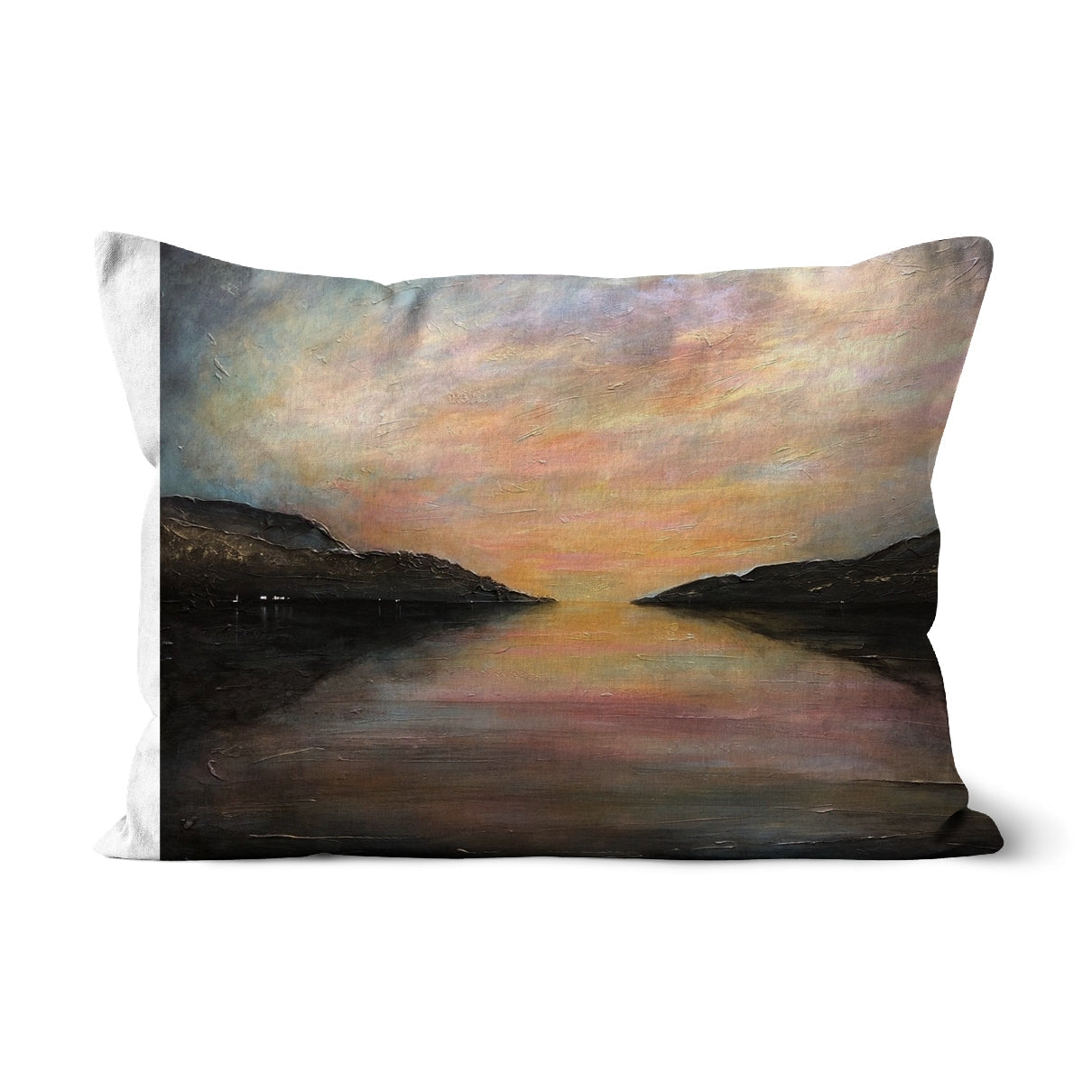 Loch Ness Glow Cushion: white pillow with abstract sunset in orange-pink hues, black hill silhouettes reflected in water