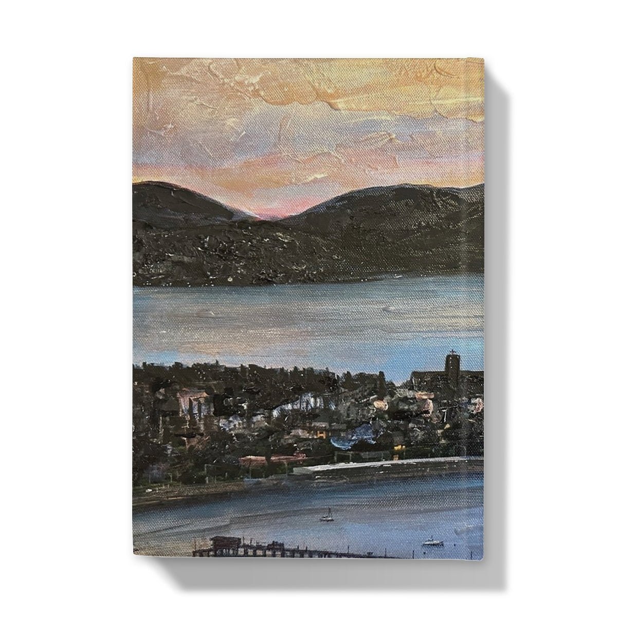 Canvas print of coastal town with mountains and sunset sky on Lyle Hill Hardback Journal