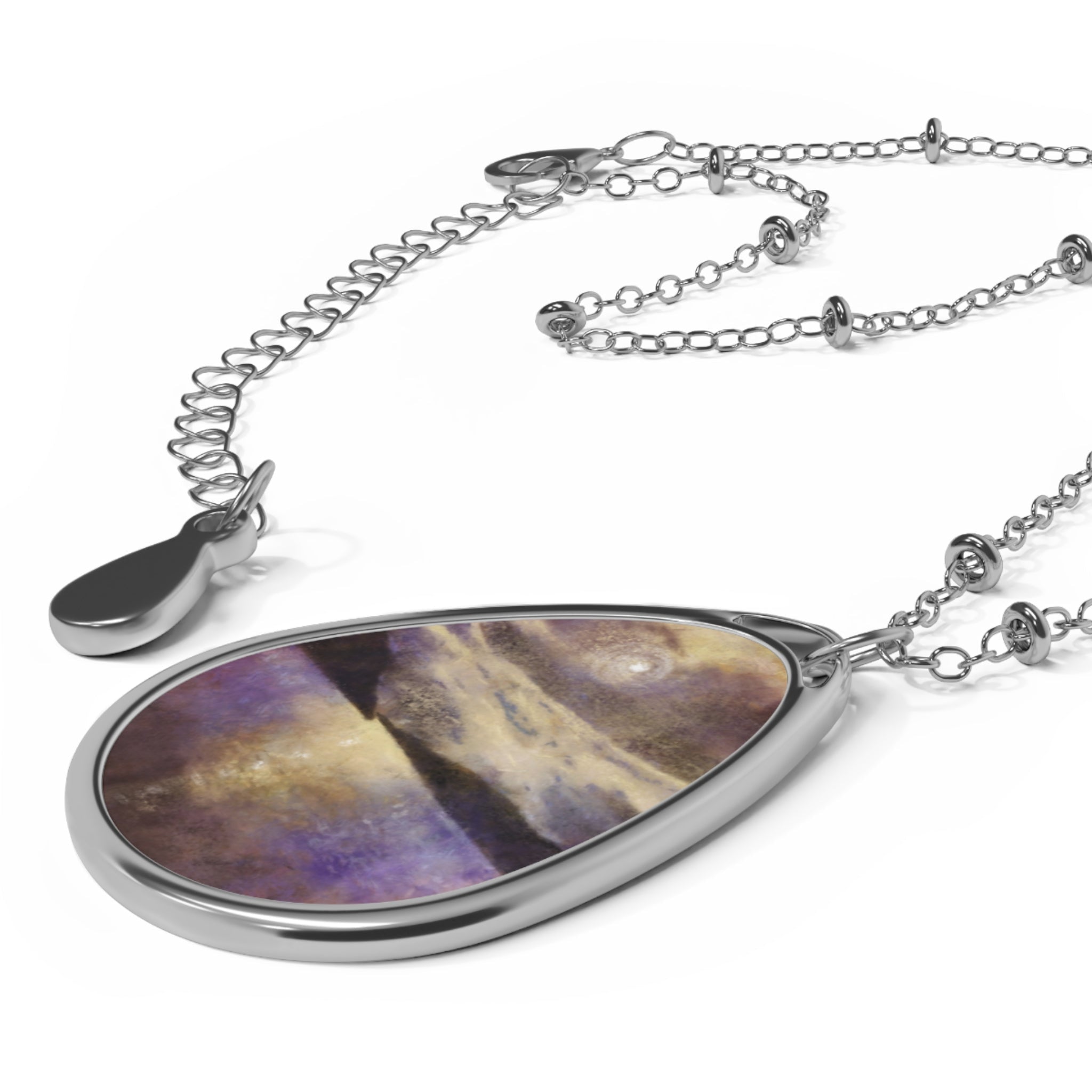 Silver chain necklace with pear-shaped pendant featuring purple and gold abstract design