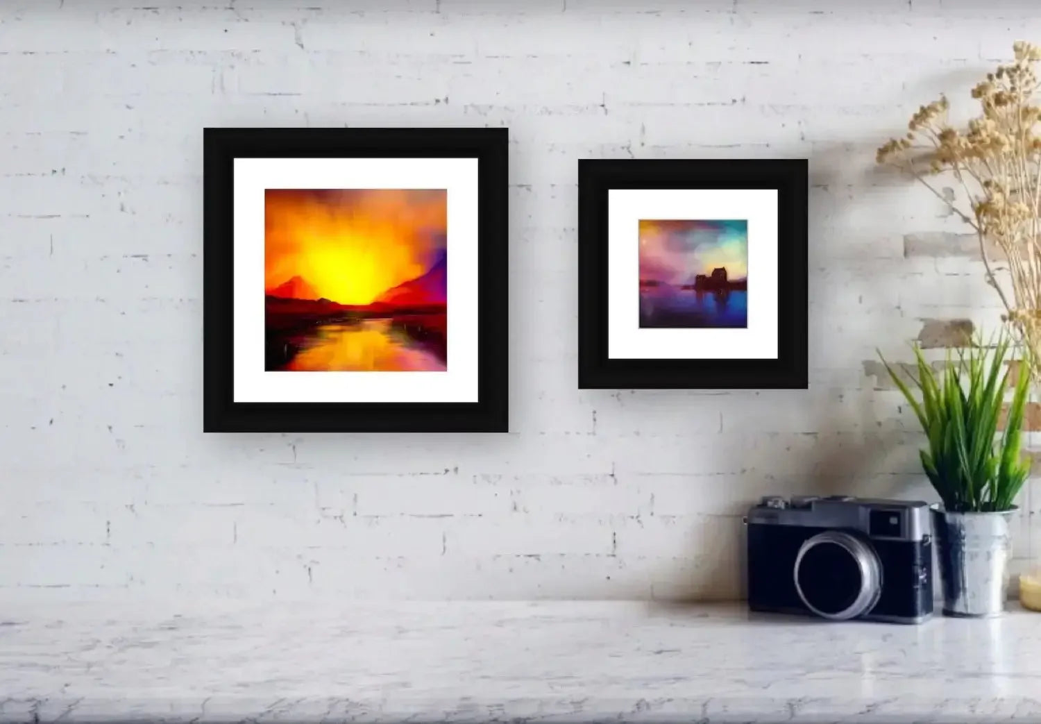 Two framed landscape paintings on a white brick wall in A Moonlit Croft Scotland In Your Pocket