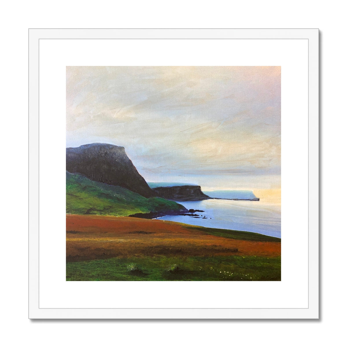 Neist Point Cliffs art print: white-framed landscape with green hills, blue water, cloudy sky