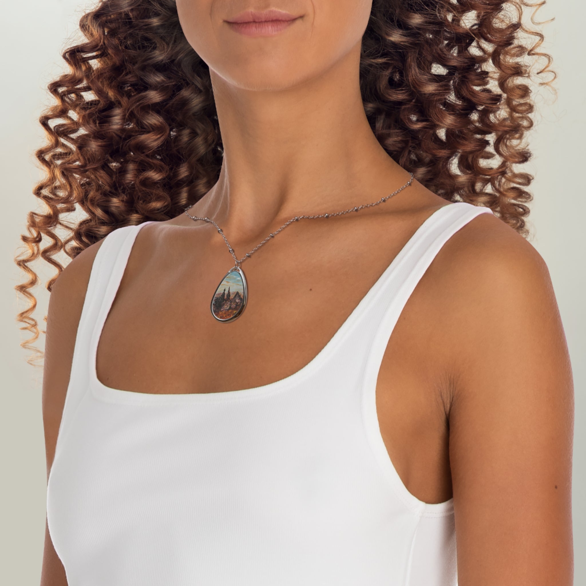 Woman wearing white tank top and teardrop-shaped pendant necklace from The Old Man Of Storr Skye Scottish Jewellery collection