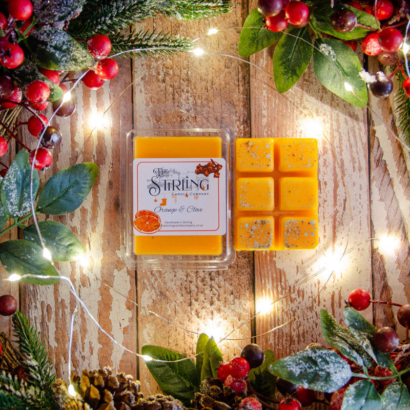 Orange & Clove wax melt clamshell with 6 speckled metallic squares