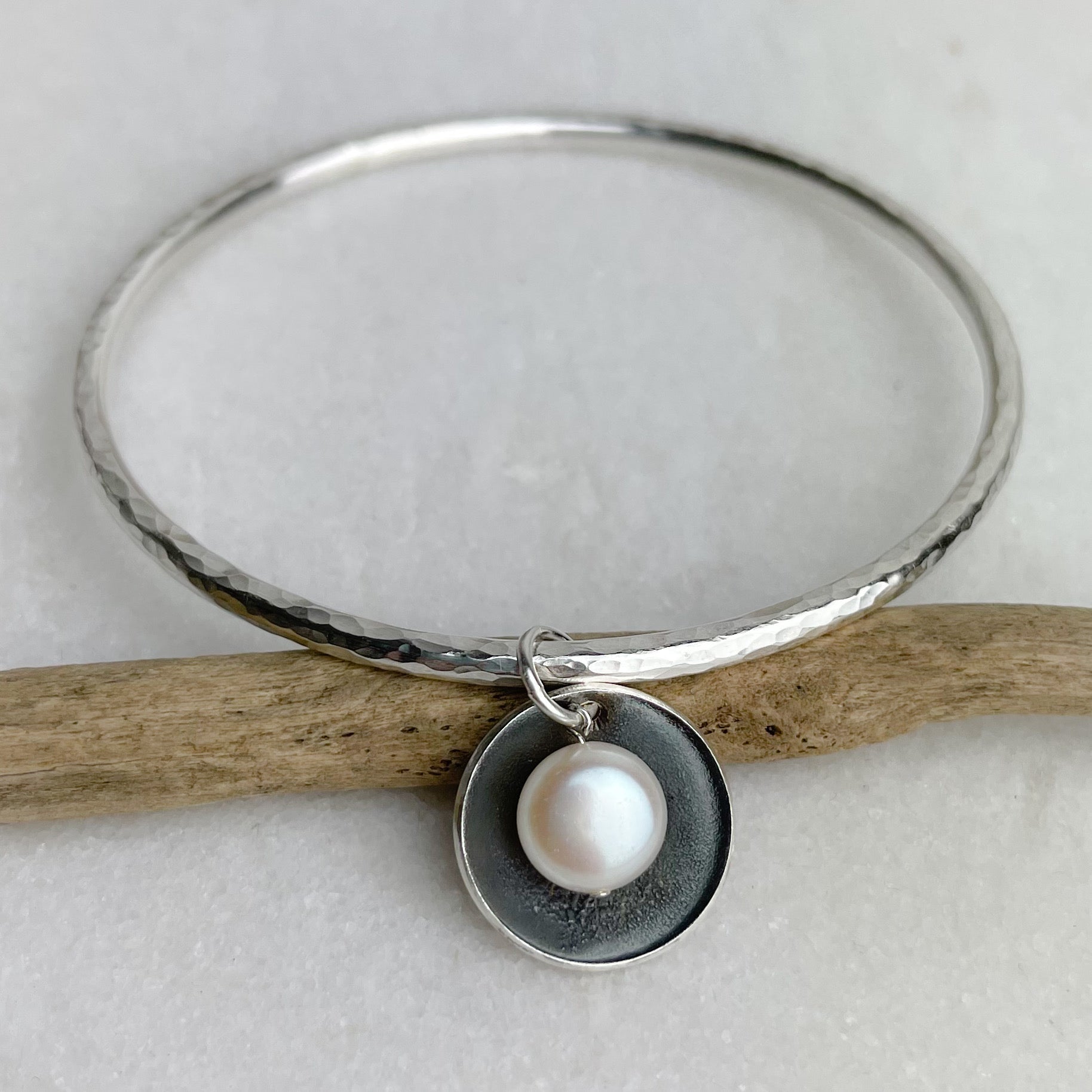 Silver hammered Oyster bangle with pearl pendant by Lindsay Mcdowall Jewellery