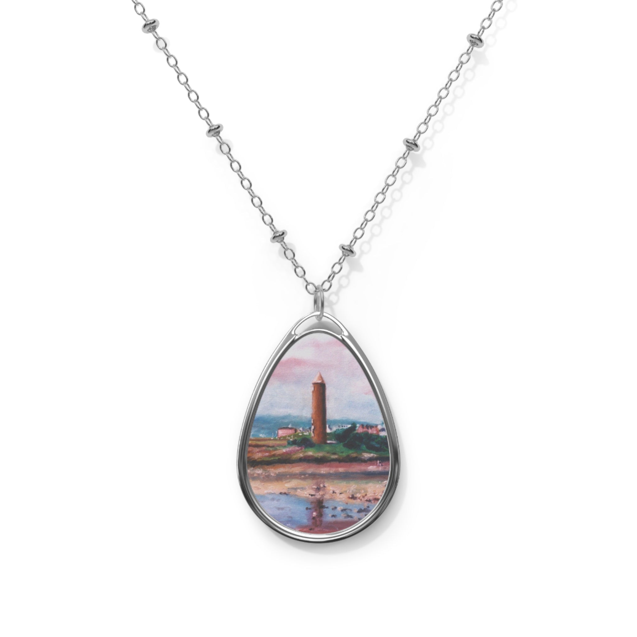 Silver chain necklace with oval pendant depicting a Scottish lighthouse by the sea