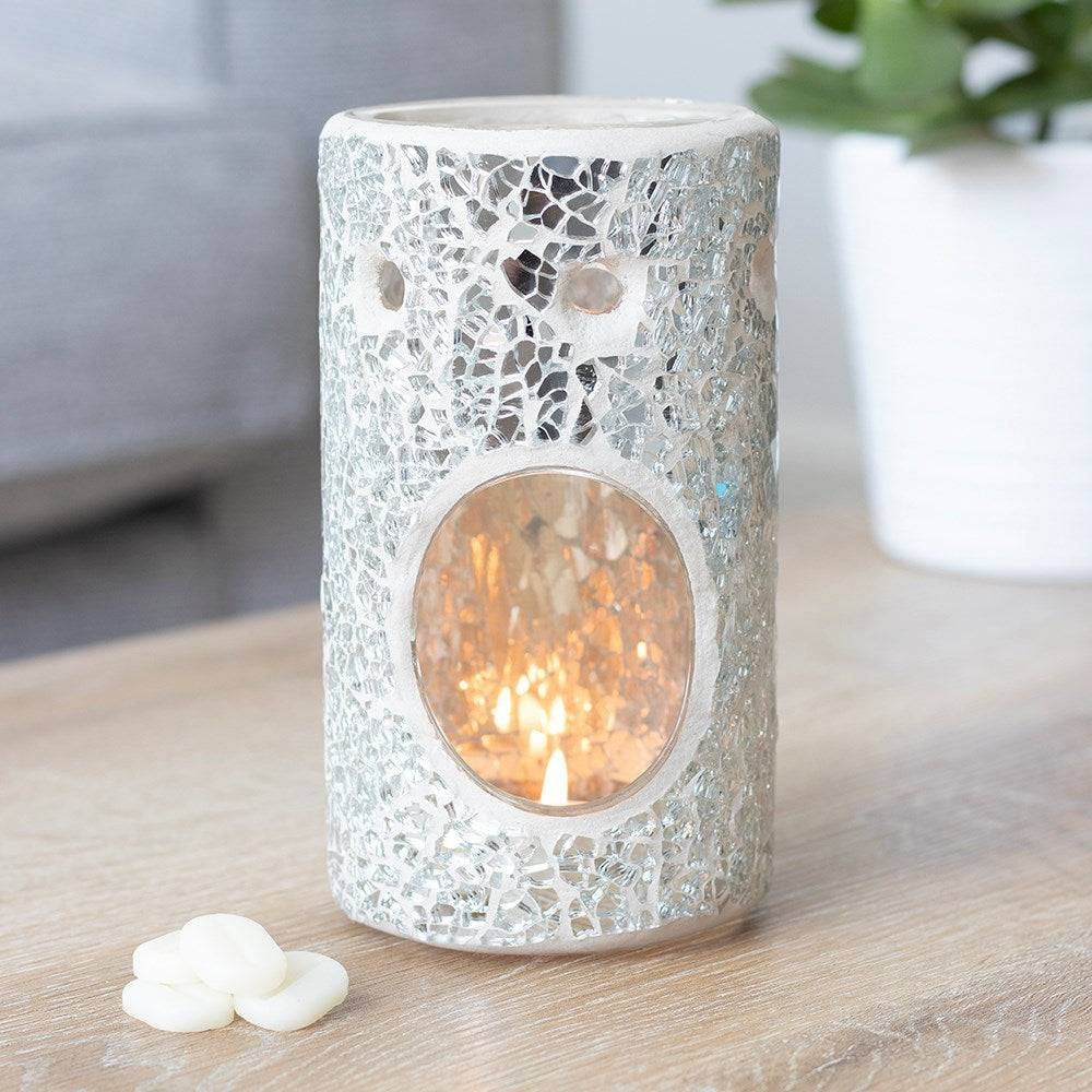 Silver mosaic ceramic oil burner with illuminated candle in circular glass window