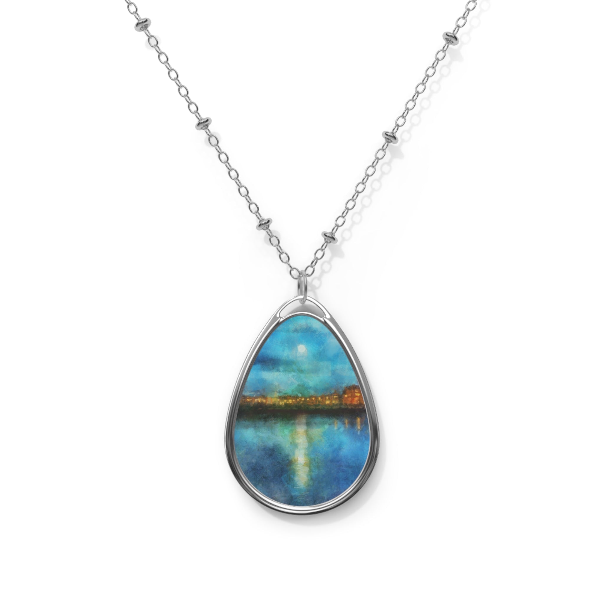Silver chain necklace with oval pendant featuring a painted cityscape reflecting on water