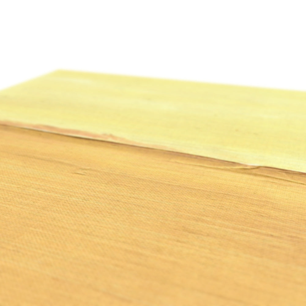 Pale yellow textured paper sheet on light wood, The Sand Dune Canvas