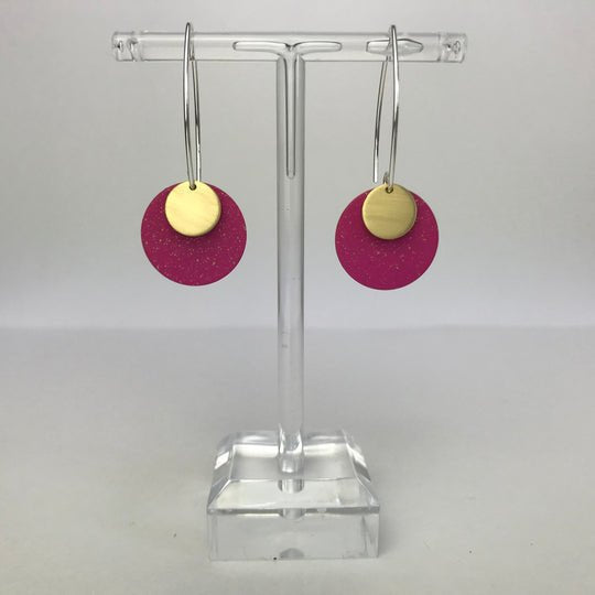 Fuchsia glittery Santa Cruz small dot earrings with gold disc on acrylic stand