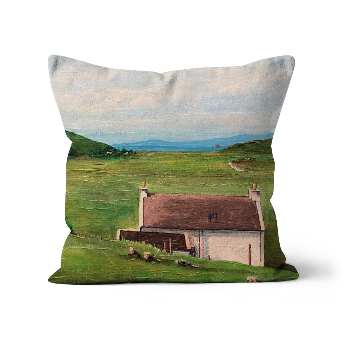Decorative throw pillow with landscape painting of a house in a green field by the sea