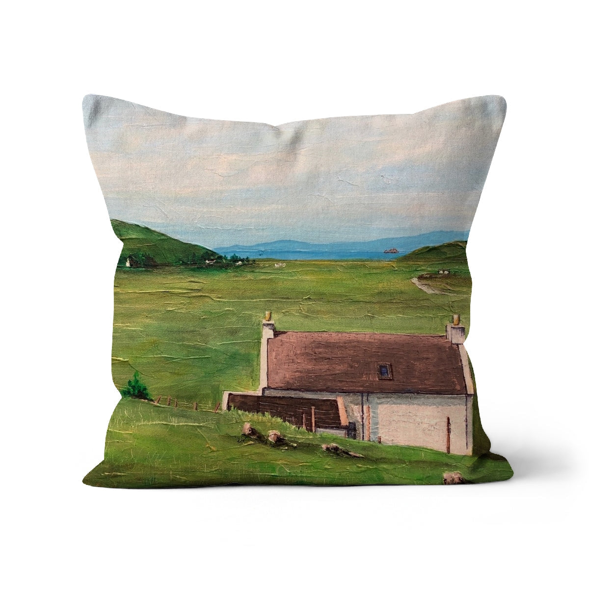 Decorative Skye Cottage Cushion with landscape painting of a house in a green field