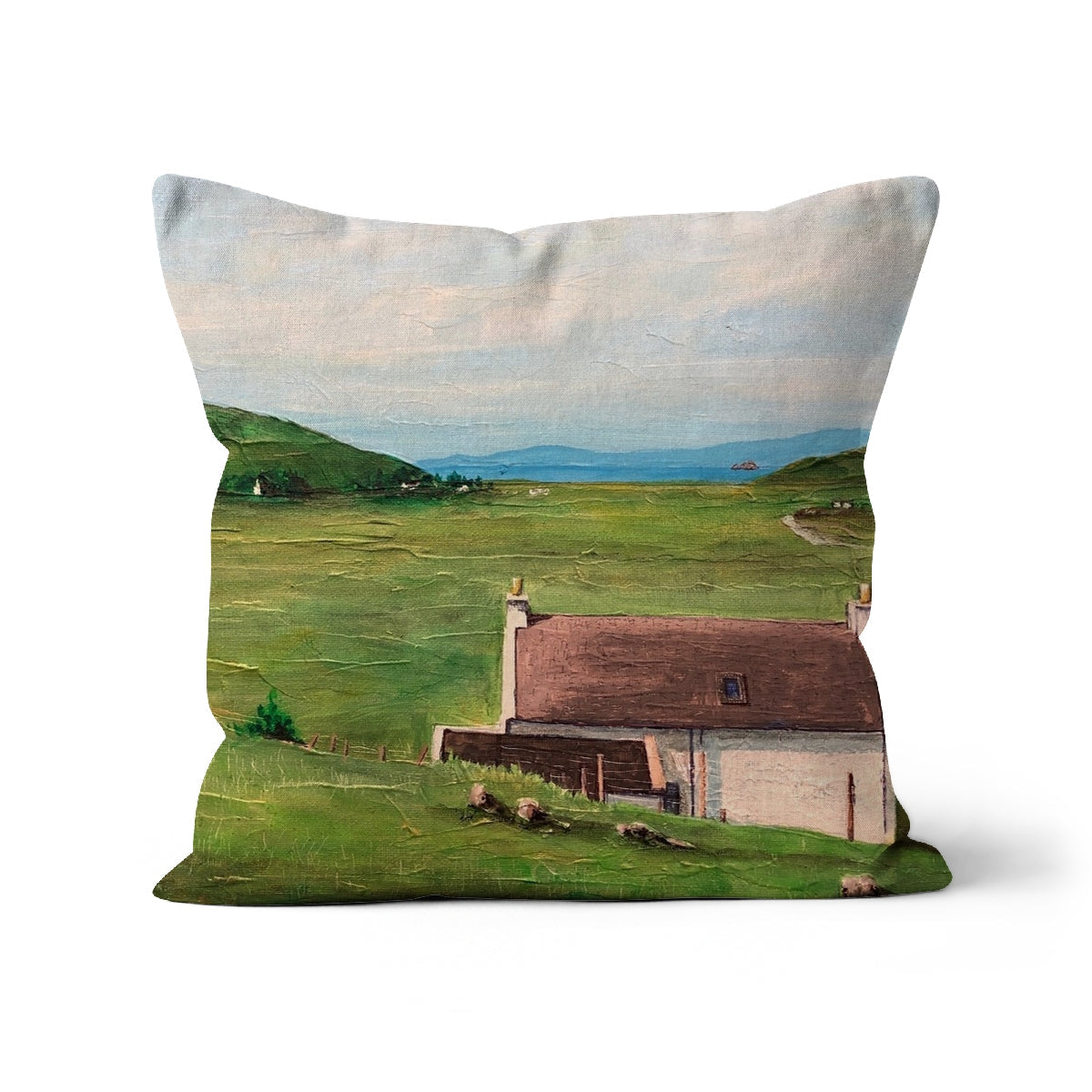 Decorative Skye Cottage Cushion with landscape painting of house, green fields, and hills