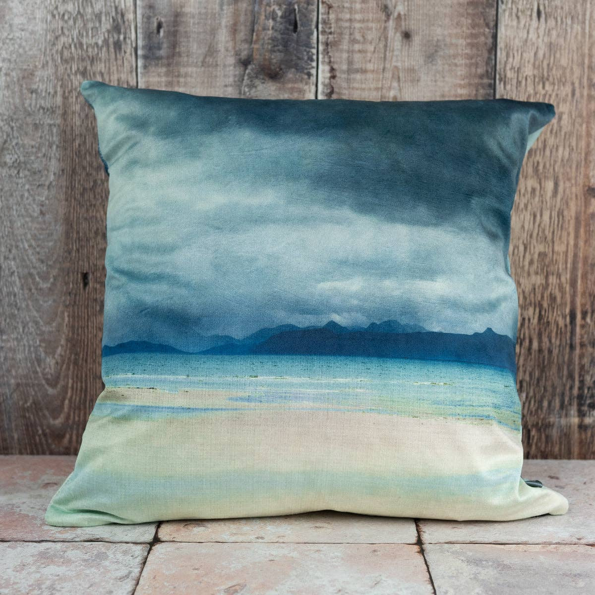 Square Skye and Raasay velvet cushion with serene coastal scene