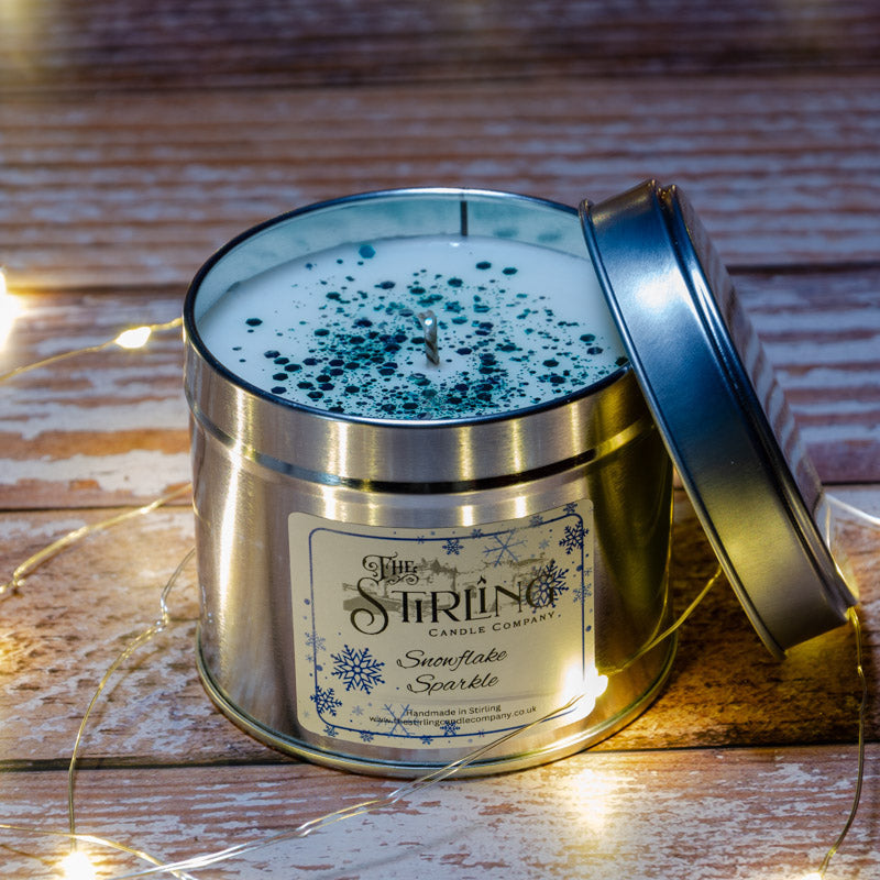 Snowflake Sparkle silver travel tin candle with teal glitter wax by Stirling Candle Company