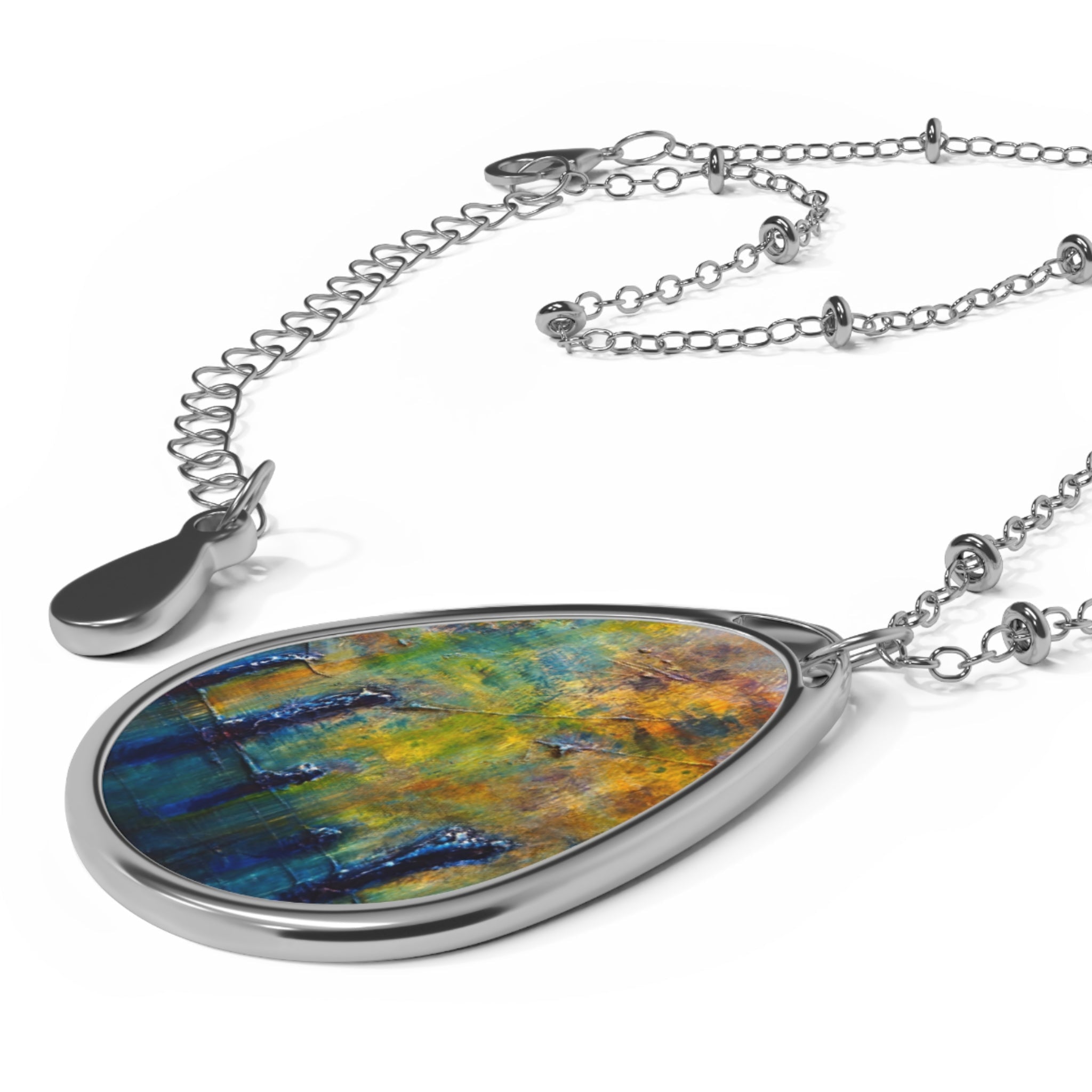 Silver-toned teardrop necklace with colorful abstract design from Stenness Moonlight collection