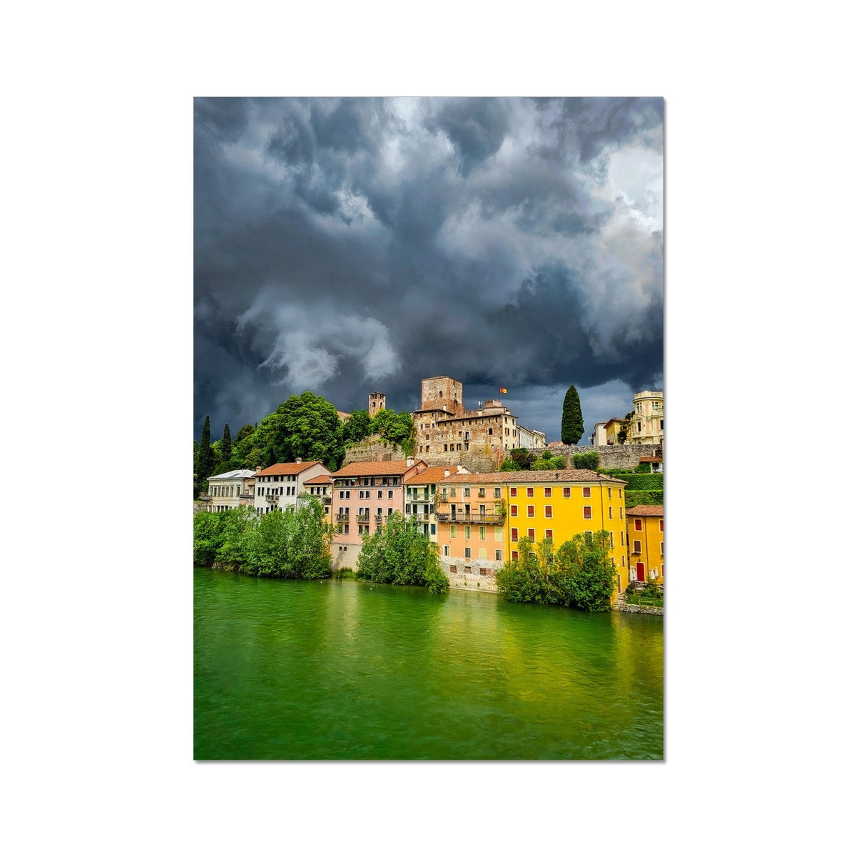 Stormy Bassano del Grappa: yellow terracotta buildings by green river