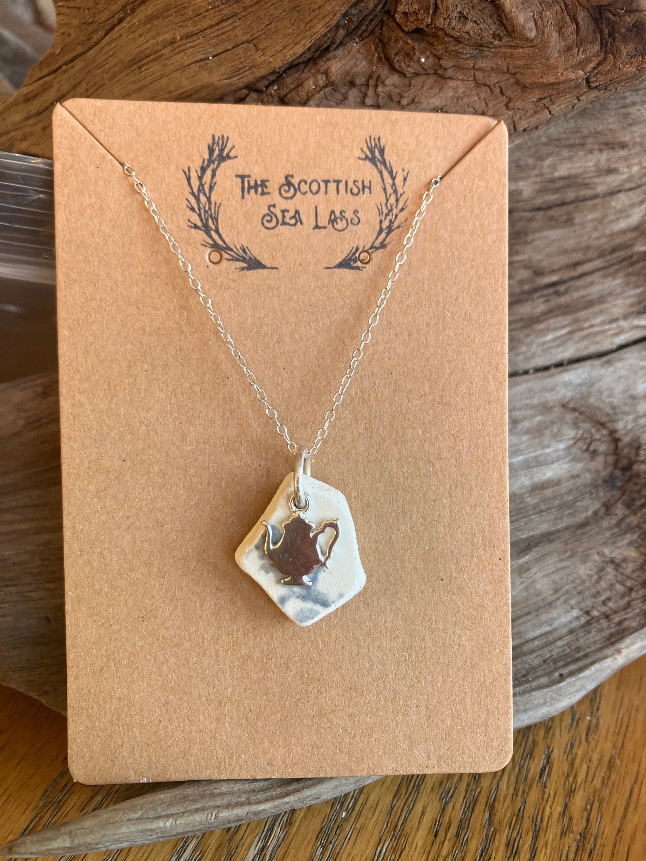 Silver chain necklace with white sea glass shard pendant featuring a silver Teapot design