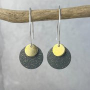 Teide small dot earrings with matte black and gold-toned discs by Lindsay Mcdowall Jewellery