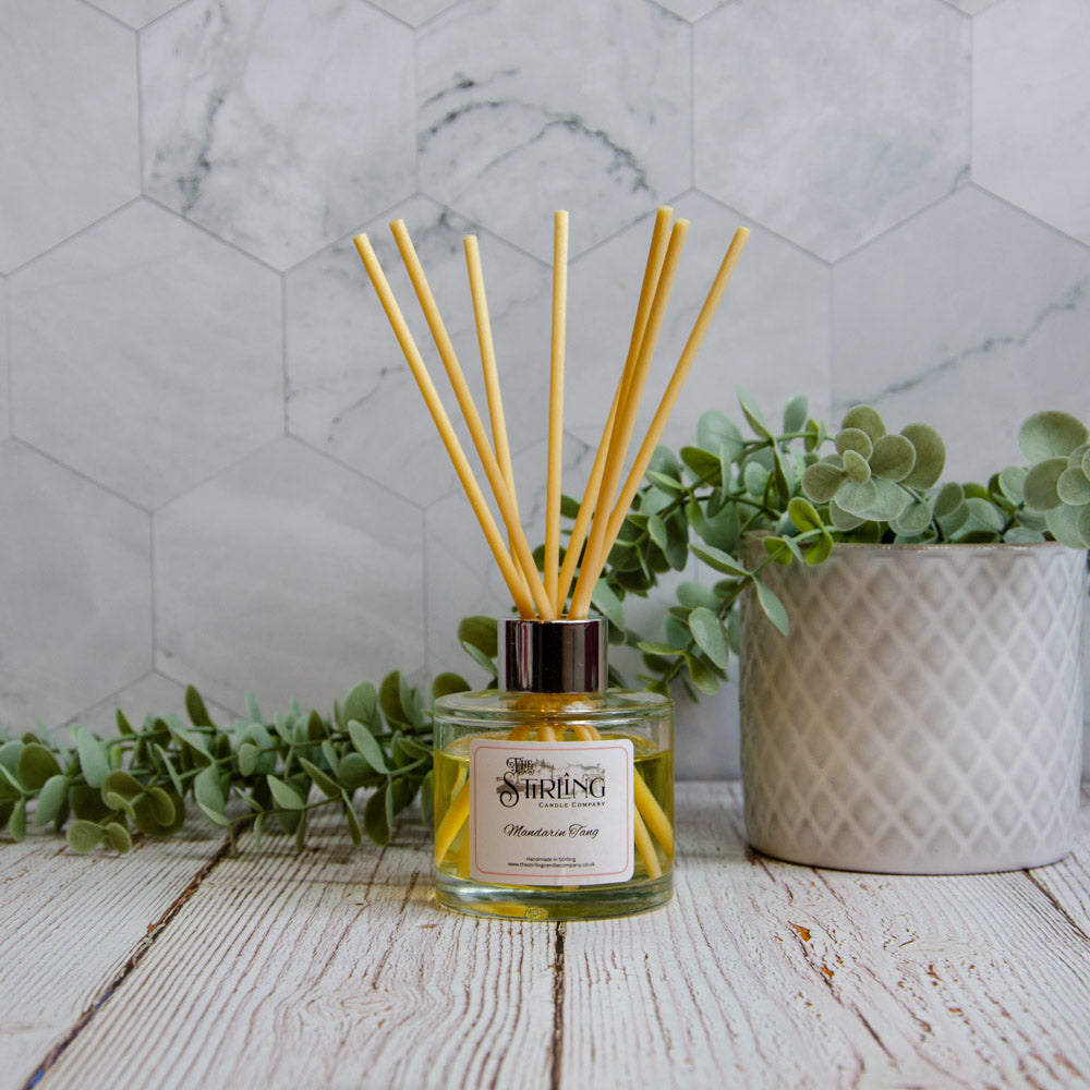 Clear glass mandarin tang reed diffuser with metallic cap and yellow reeds by stirling castle company 100ml
