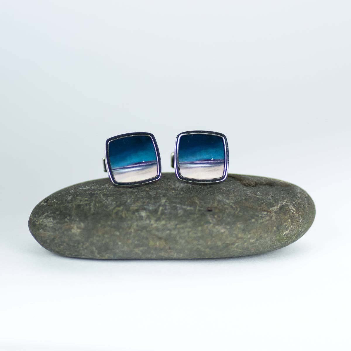 Square silver cufflinks featuring a serene ocean and beach scene from the uist machair collection