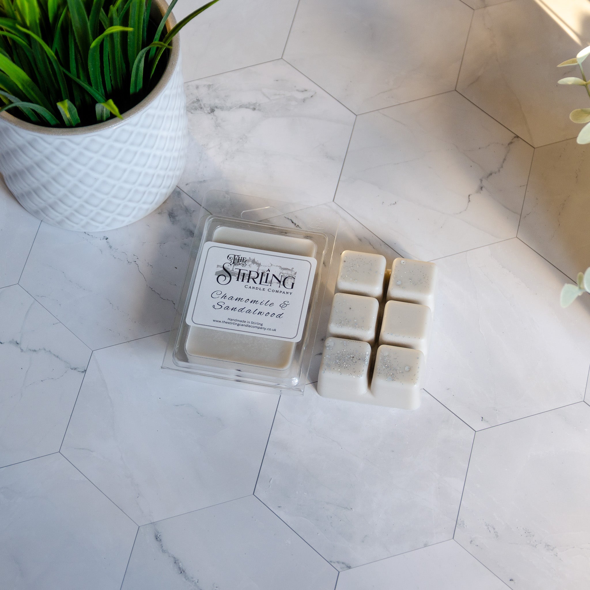White chamomile and sandalwood scented wax melt clamshell in clear plastic tray from stirling candle company