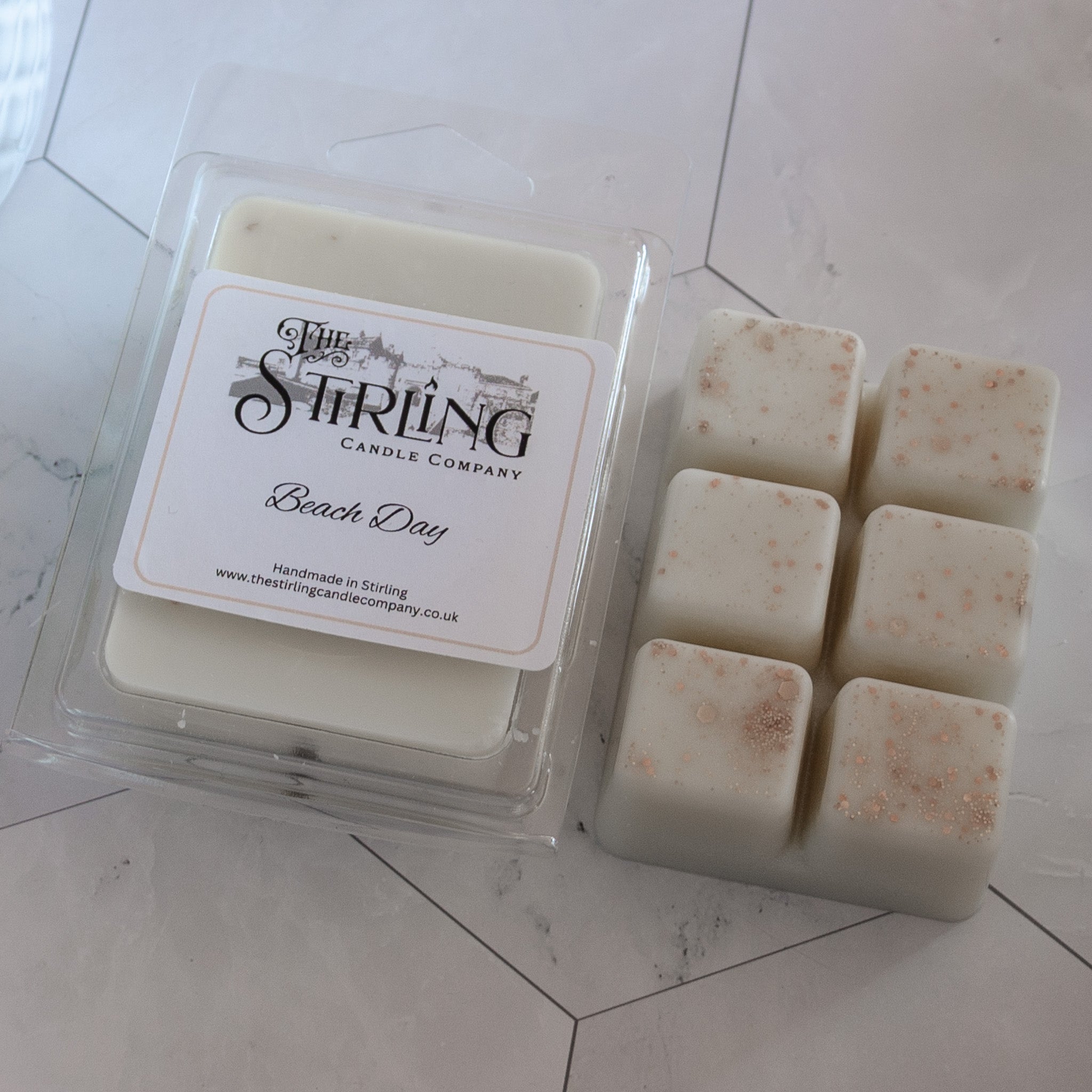 White beach day wax melt clamshell from stirling candle company with six square wax pieces in clear plastic tray
