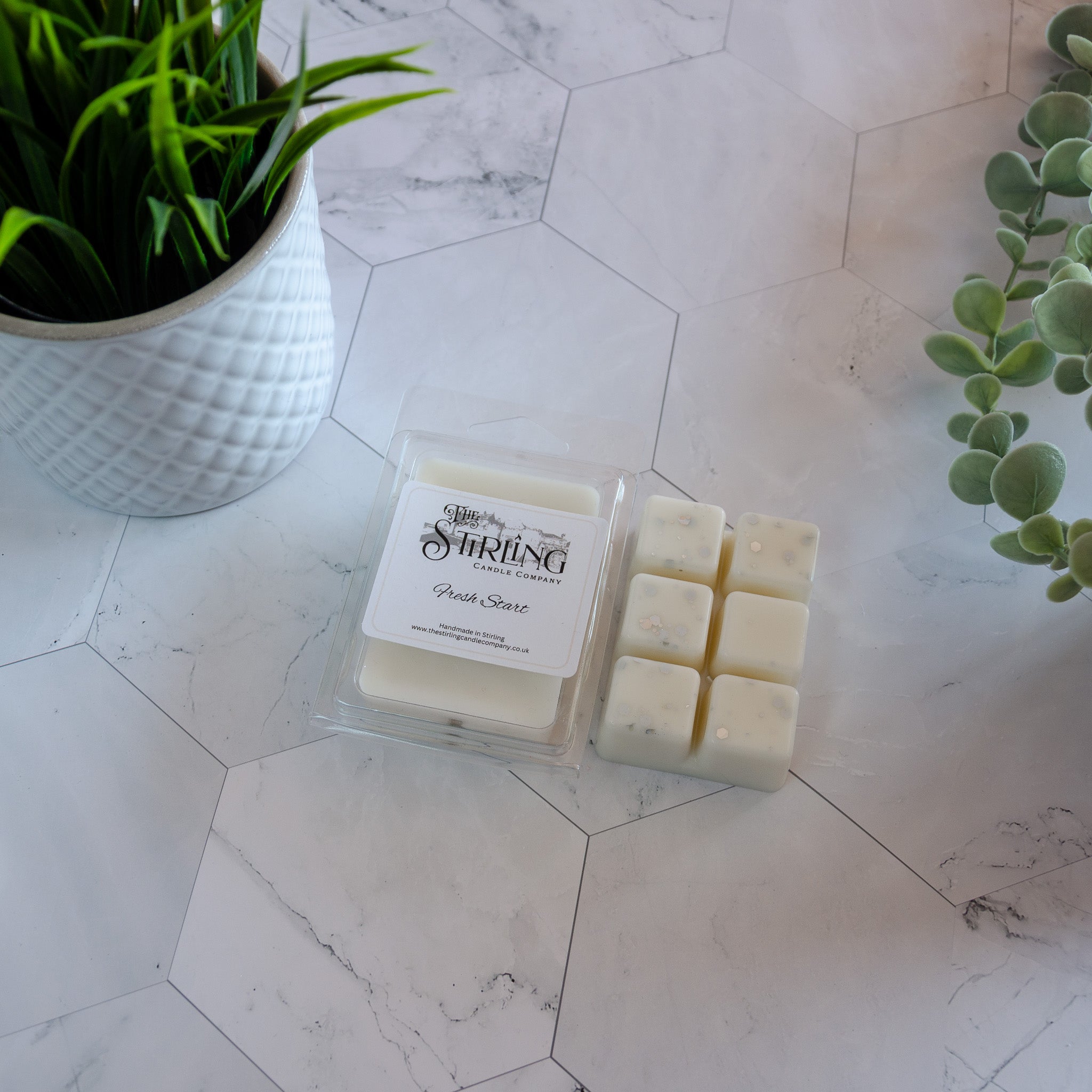 Fresh start wax melt clamshell with white wax cubes in clear container from the string candle company