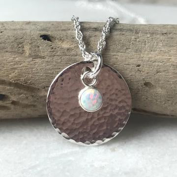 Silver hammered disc pendant necklace with central white opal, Lindsay McDowall Jewellery