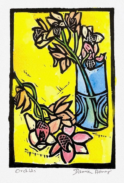 Blue vase with swirling patterns holding pink and peach orchids on yellow background in Yellow Orchids framed print